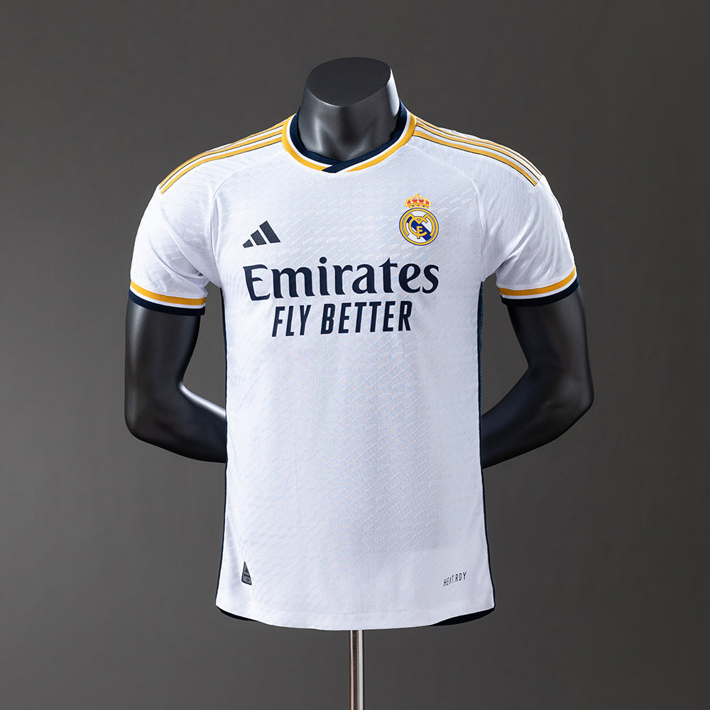 Real Madrid 2425 Home Jersey displayed on a mannequin, featuring white fabric and contrasting details.