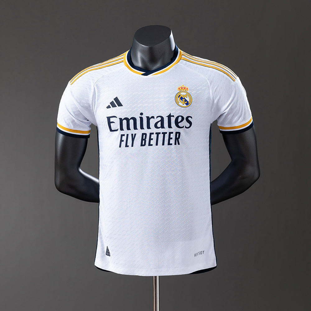 Real Madrid 2425 Home Jersey displayed on a mannequin, featuring white fabric and contrasting details.