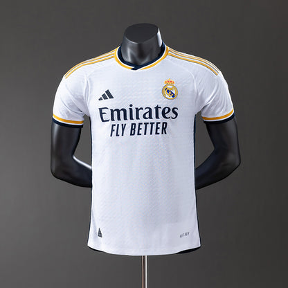 Real Madrid 2425 Home Jersey displayed on a mannequin, featuring white fabric and contrasting details.