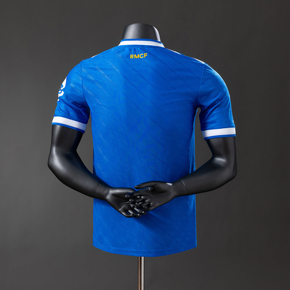 Real Madrid 2526 Third Jersey displayed on a mannequin from the back, showcasing its blue color and RMFC logo.