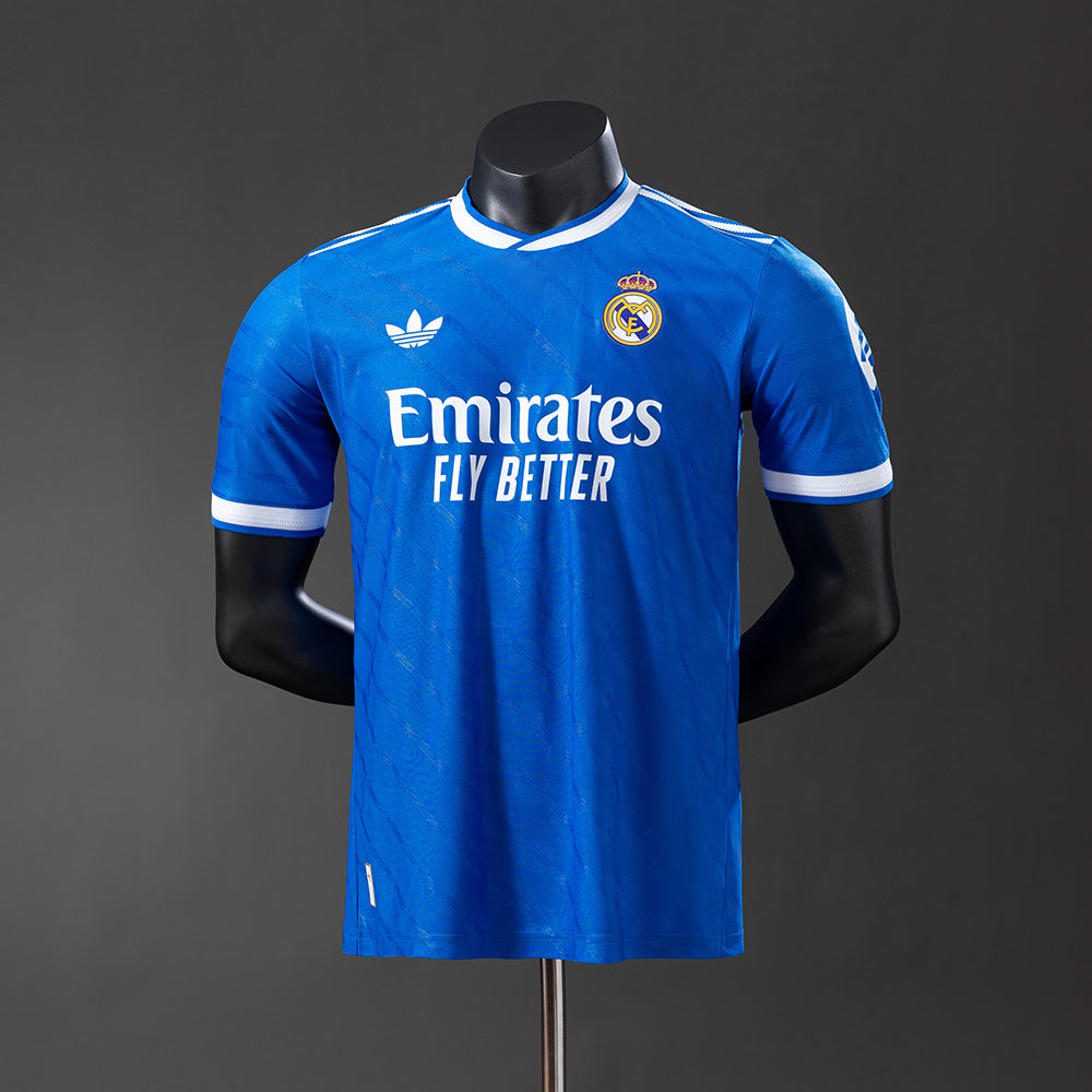 Real Madrid 2526 Third Jersey displayed on a mannequin, showcasing the iconic blue design and club emblem.